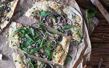 Vegetarischer Flammkuchen mit Rucola und Pilzen